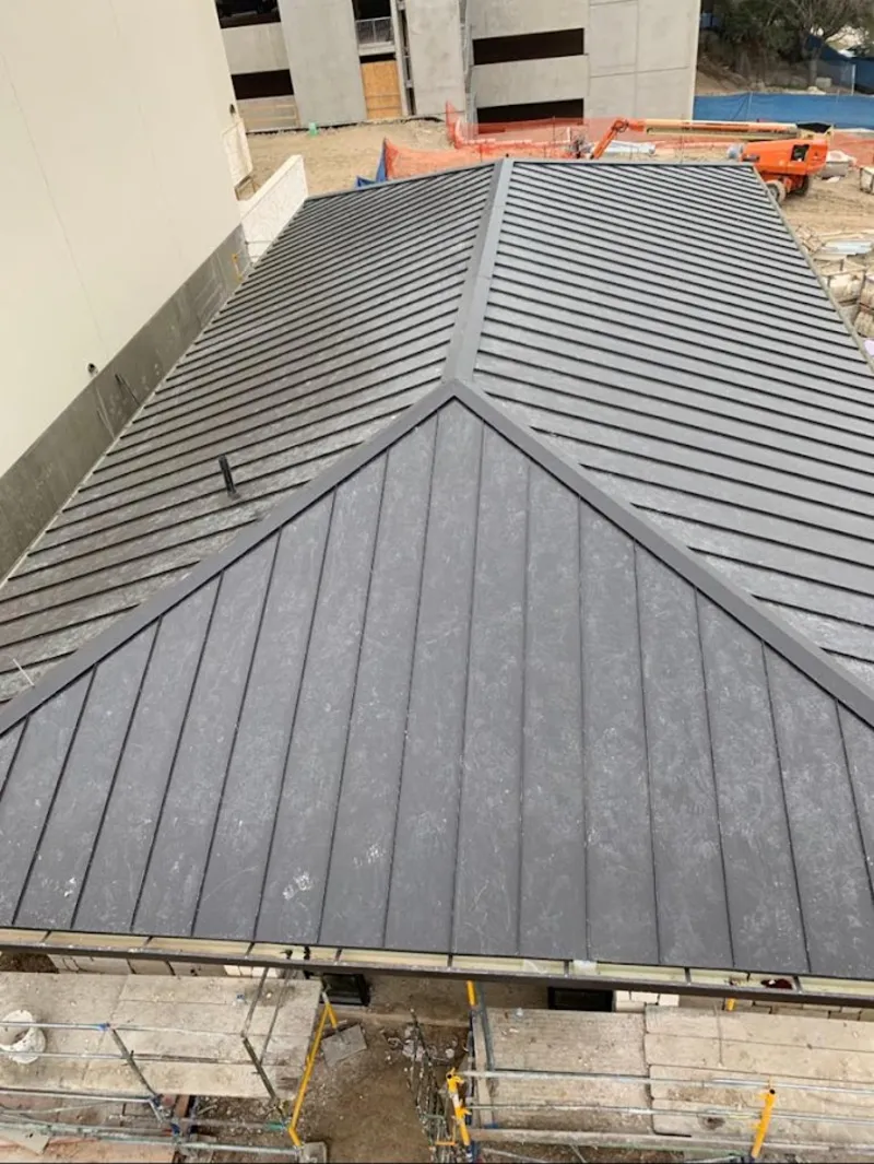 Commercial metal roof construction with crane equipment in Guadalupe
